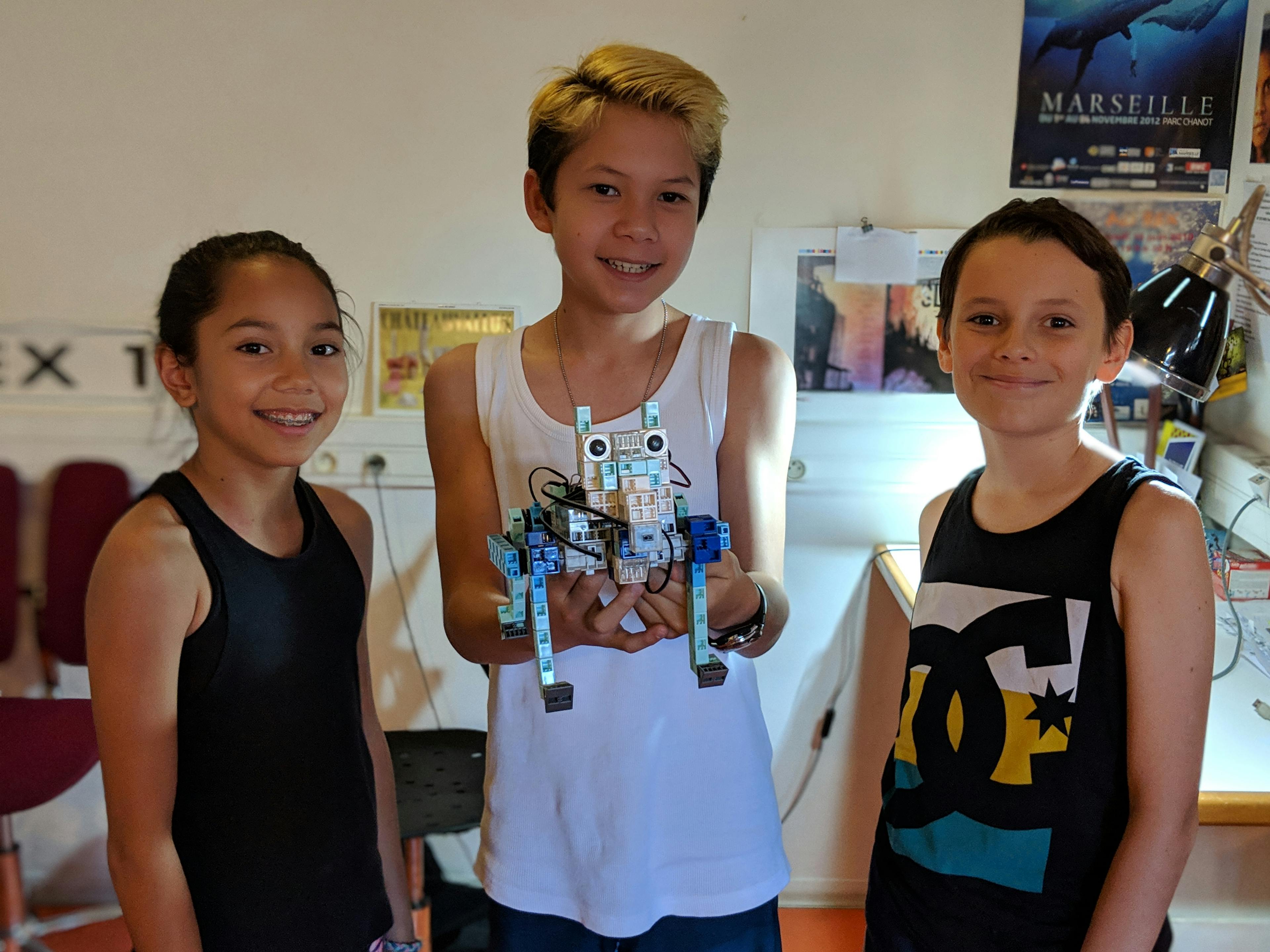3 students with their robot dog